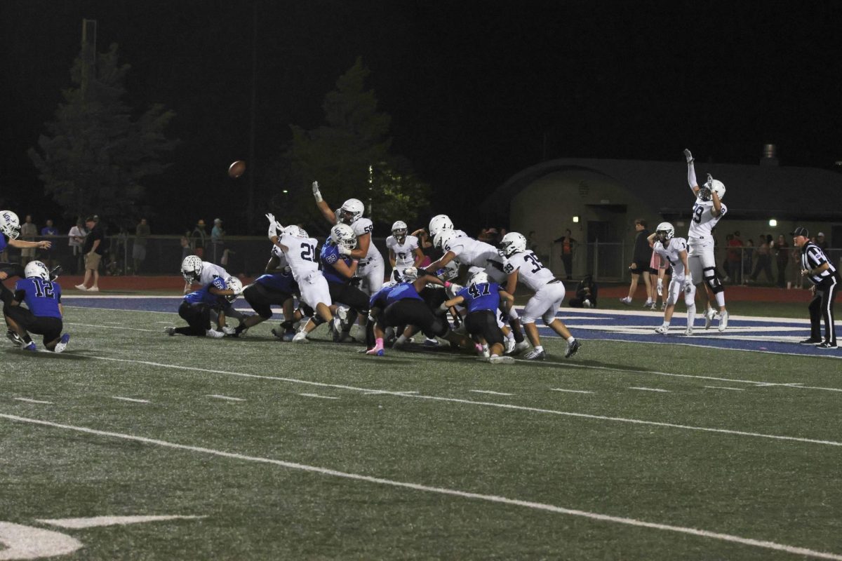 Attempting to block a kick, the defense jumps into the air. 