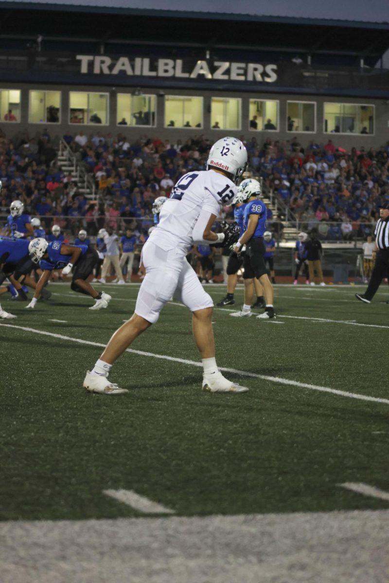 Setting up for his route, junior Blake Jay stands ready. 