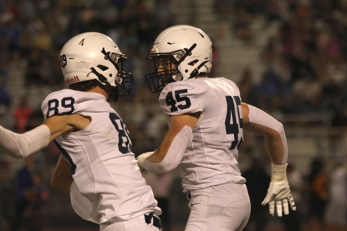 Excited about a past play, juniors Reece Riedel and Elliot Fischer go up for a chest bump. 