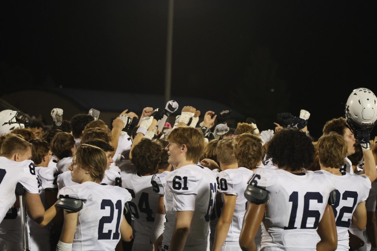 Celebrating their win, the team gets ready to break the huddle. 