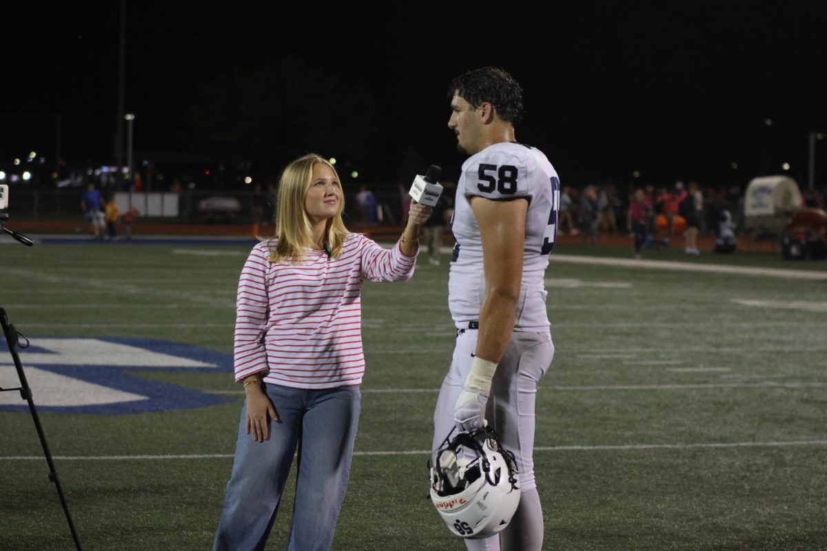 Senior Abe Shaffer talks about his gameplay with a reporter. 