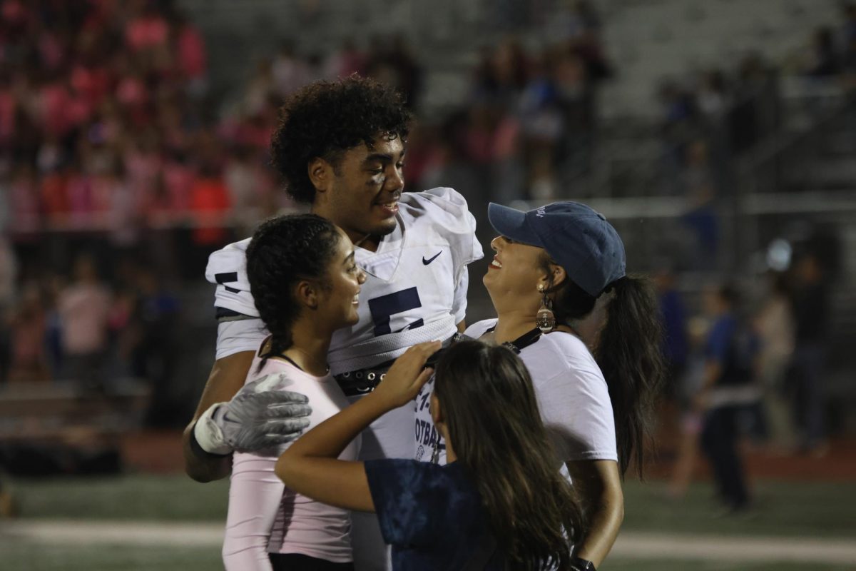 Senior Jayden Woods celebrates with family after his win. 