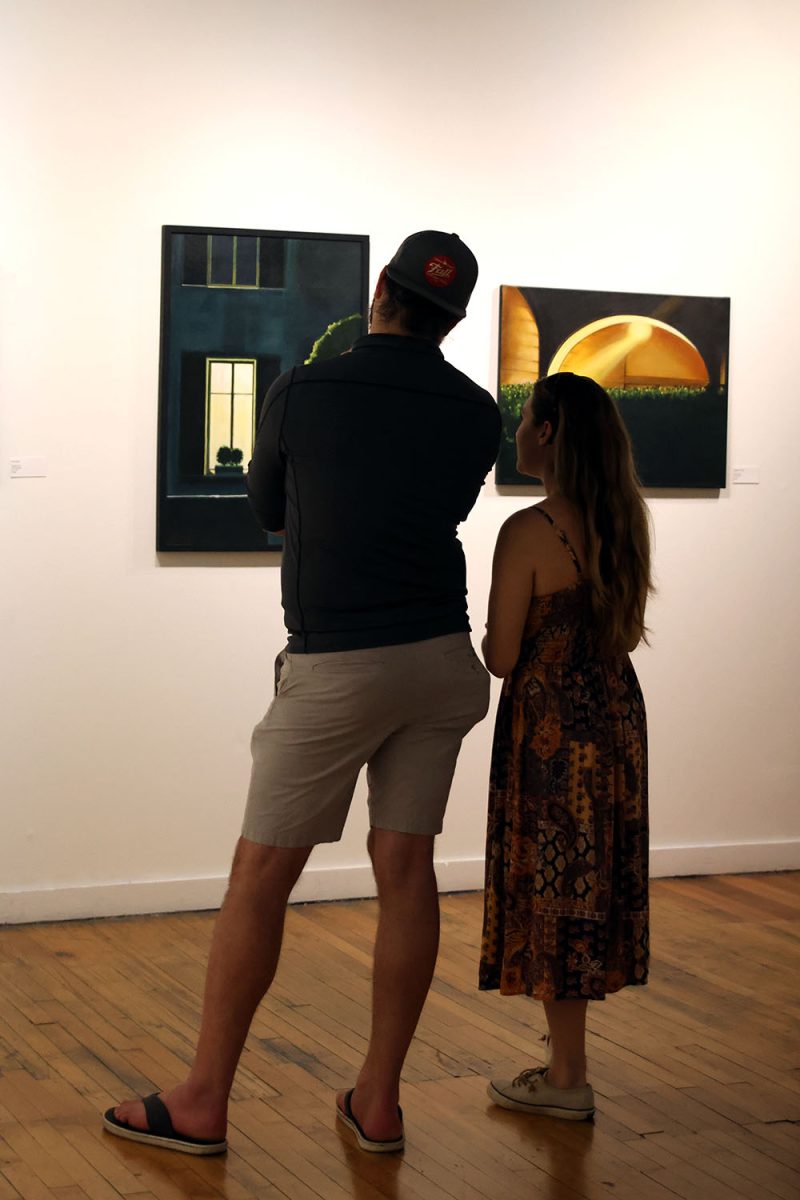 A couple discusses a oil painting by Monika Teal at The Leedy-Voulkos Art Center on Friday, Oct. 1