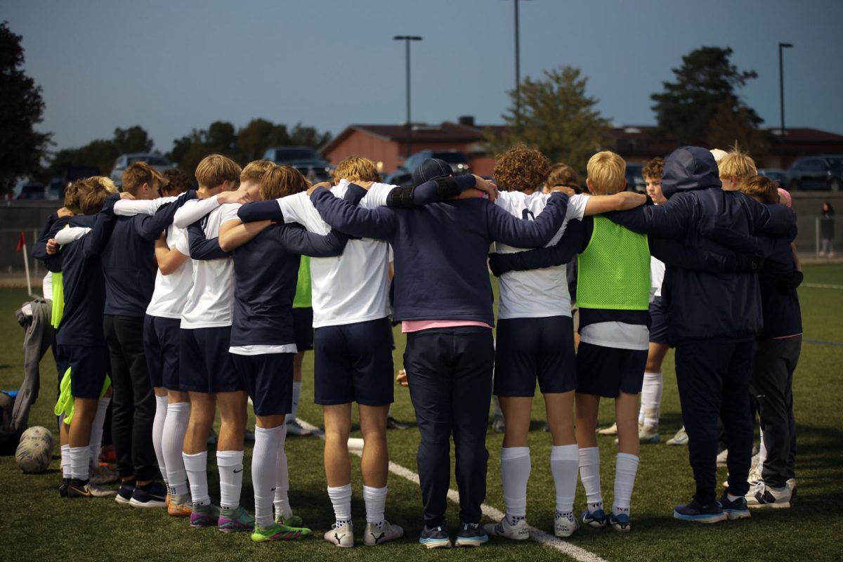 The soccer team huddles up before starting the game on Oct. 15. 