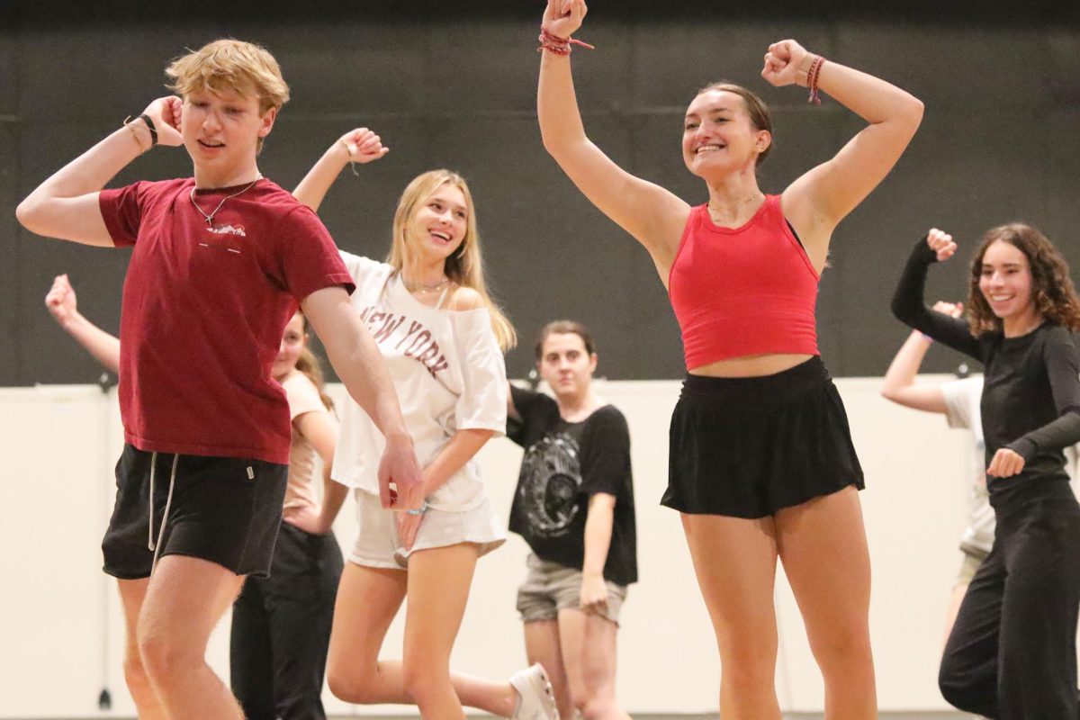 Senior Logan Koester, Junior Grace Holland, and Senior Allyson Makalous laugh as they practice dancing for footloose.