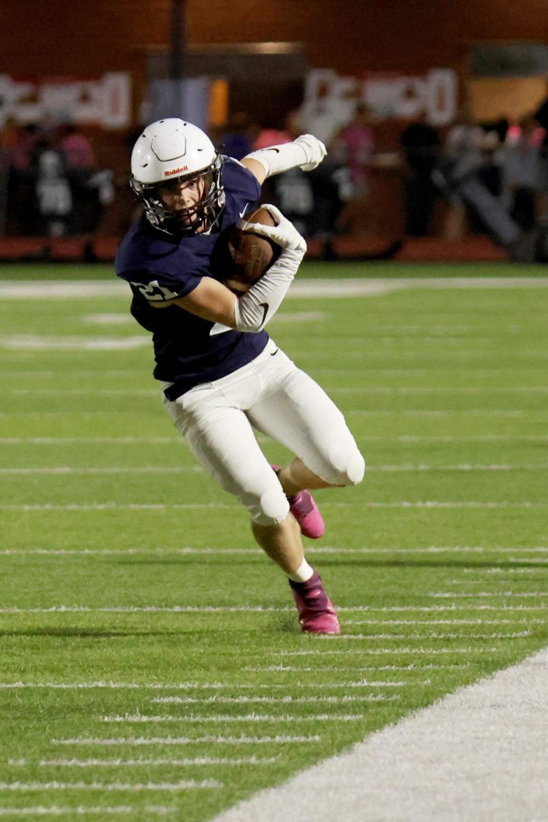 Trying to stand in bounds, senior Clayton Sondgeroth runs with the ball.
