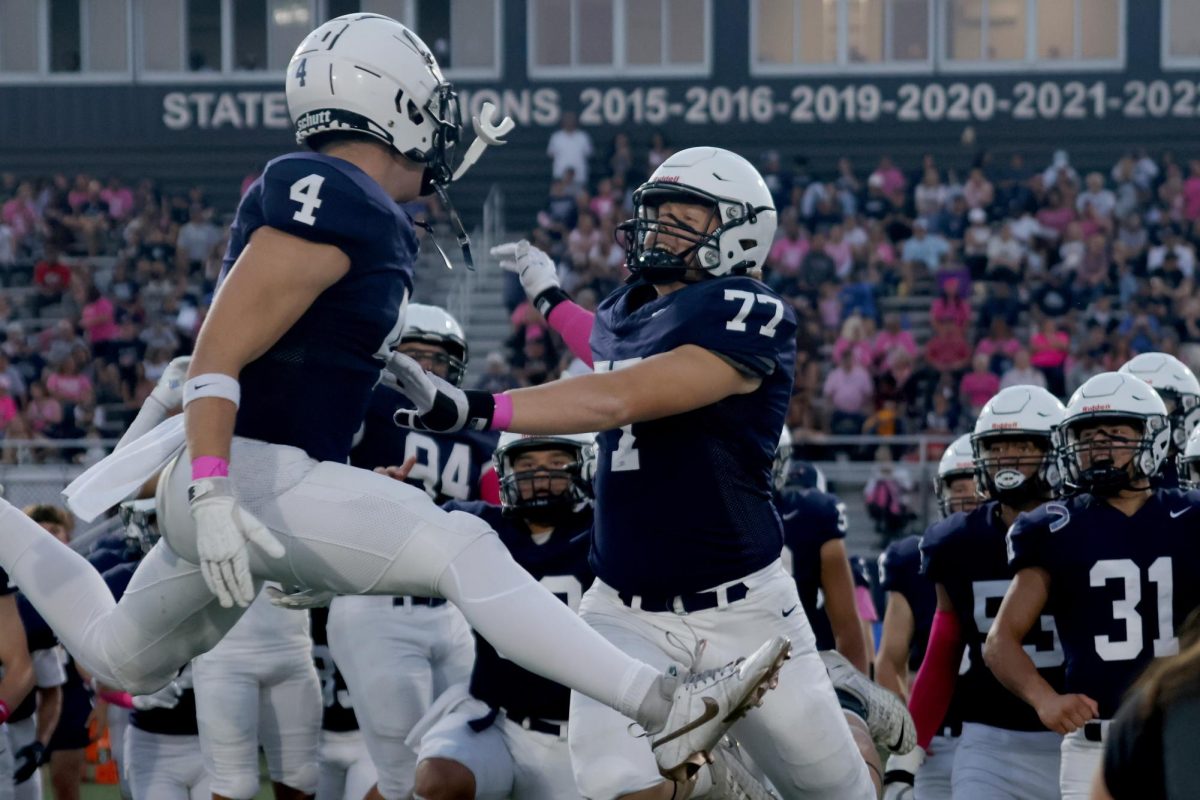 After the coin toss, seniors Garret Clark and Aiden Lehr celebrate.
