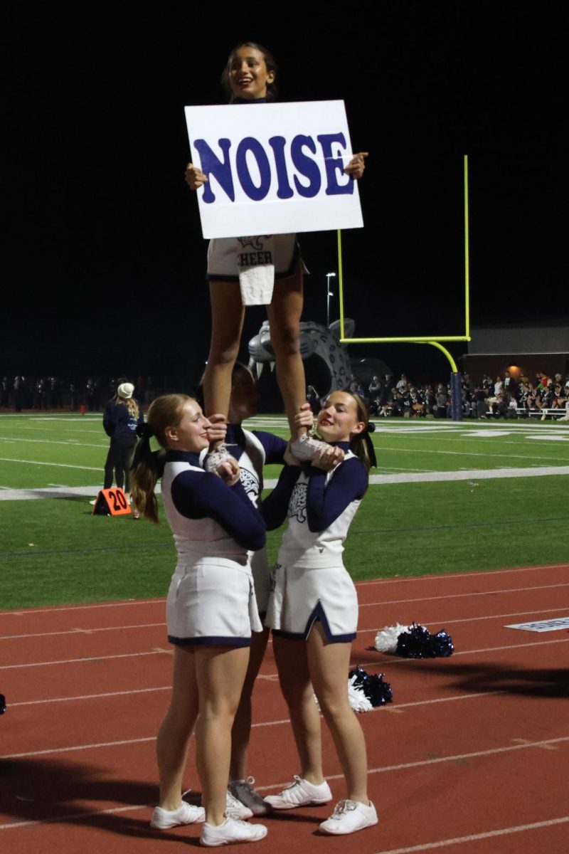 Sophomore Amanda Makalous and junior Rachel Johnston lift up Senior Jada Winfrey to get the crowd excited for a Mill Valley first down.