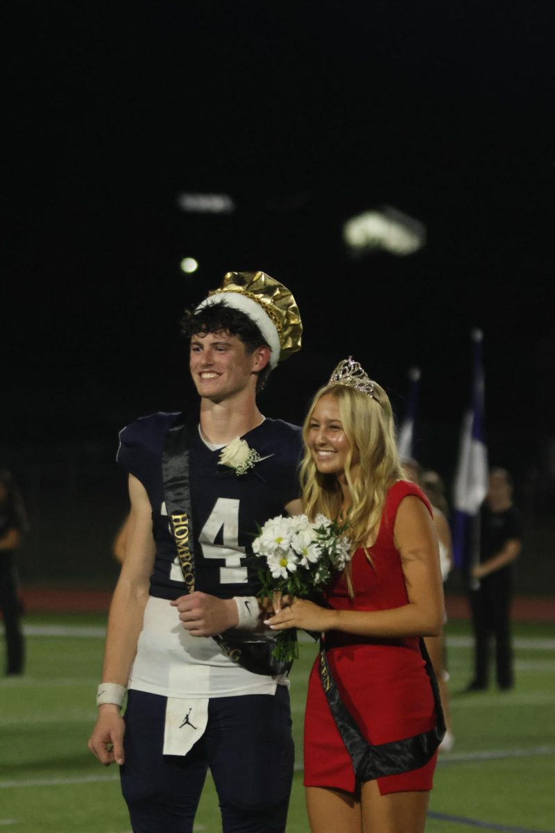 After her Homecoming Queen victory, senior Maggie Wieland meets Homecoming King Connor Bohon to take photos.