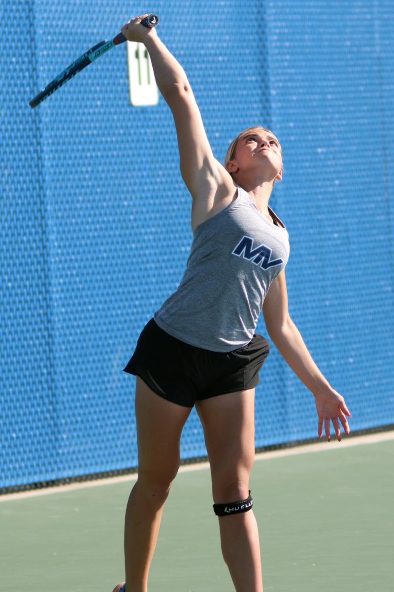 Senior Logan Miller jumps up to strike the ball. 


