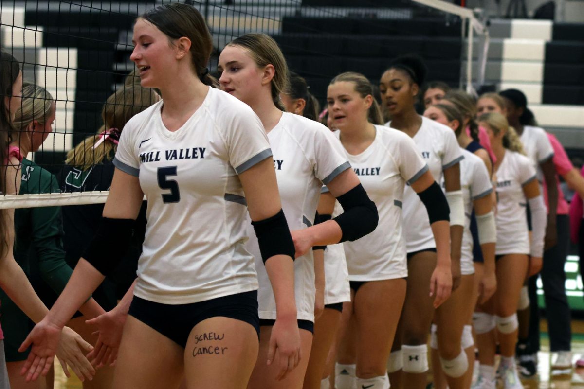 Post game, the Mill Valley and DeSoto teams show sportsmanship by low-fiving the other team. 