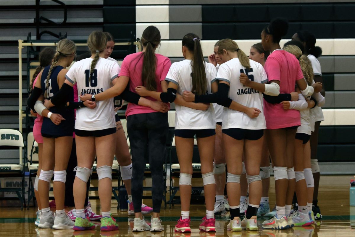 Before the game, the team huddles. 