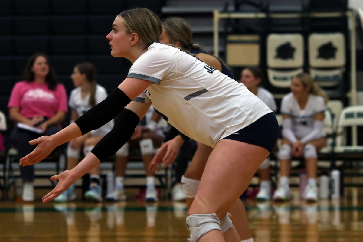 In a ready position, sophomore Riley Riggs prepares to receive the serve. 
