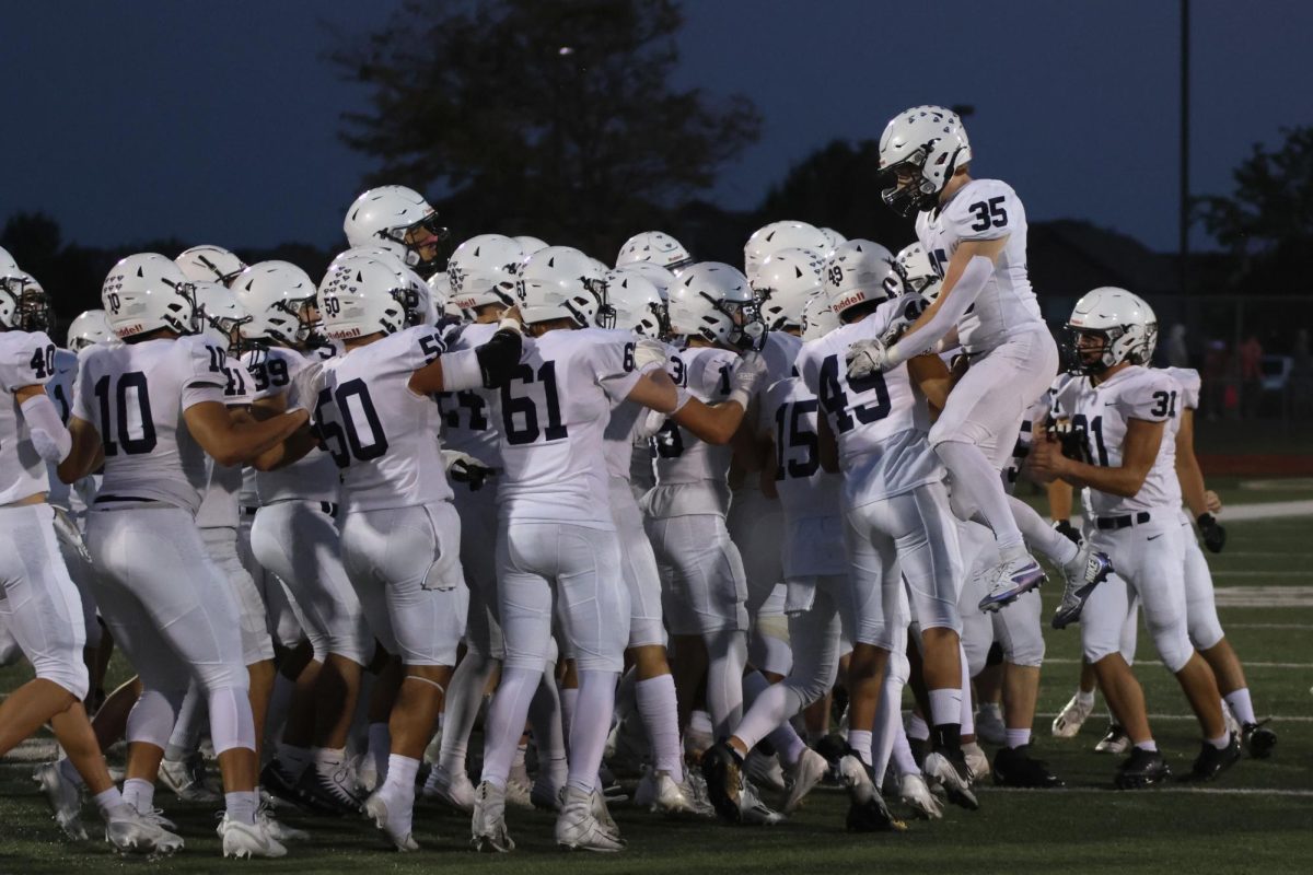 Senior Brayden Sword jumps with with excitement after winning the coin toss.