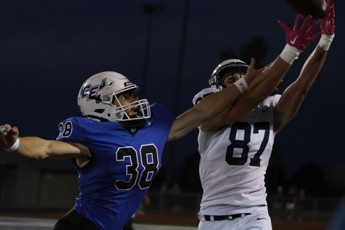 With his opponent on his side, Isaac Sauder (senior) reaches for the ball.