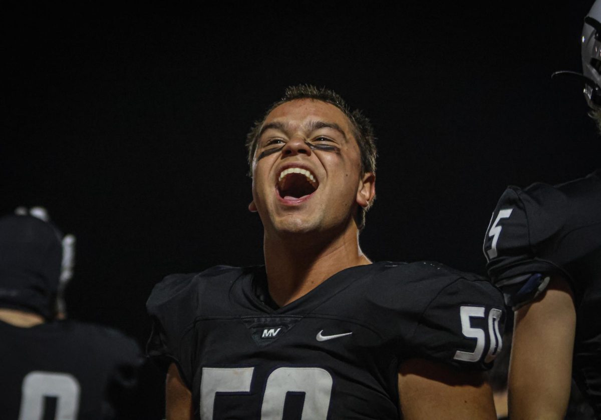 Looking towards the crowd, senior Zach Zaldivar yells in celebration. 