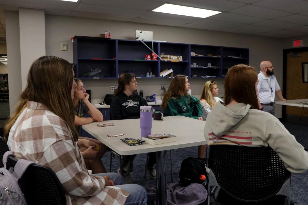 The Society of Women Engineers learns about space suit engineering from NASA engineer Kris Larson. 
