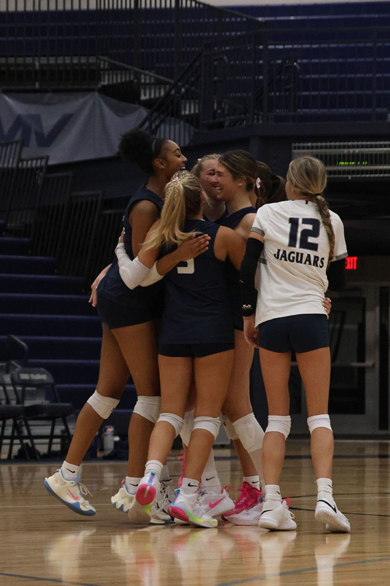 After scoring a point, the team celebrates together.