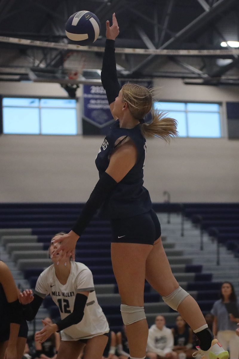 In the air, sophomore Josie Danielson hits the ball over the net Wednesday, Oct. 2.

