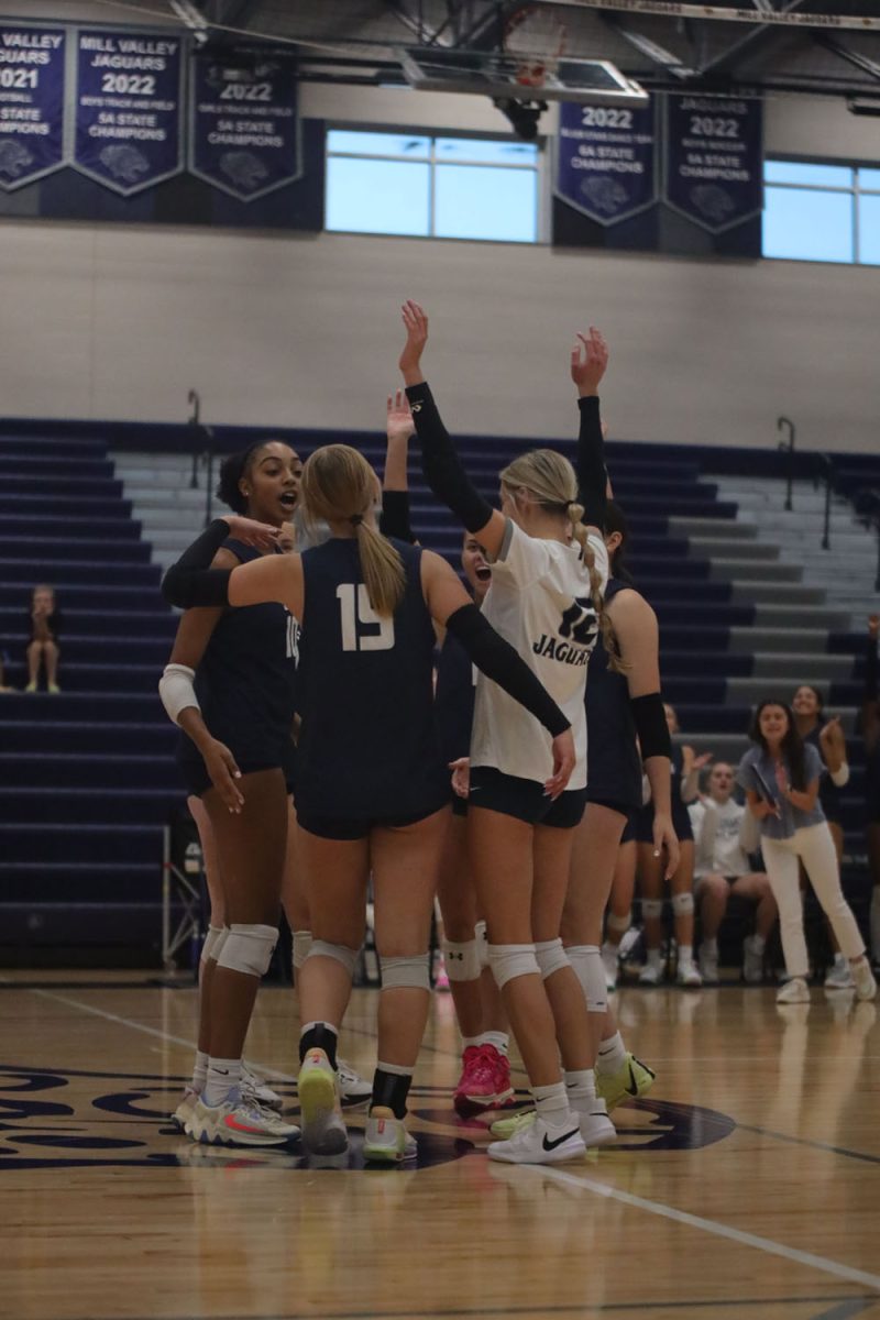 After winning a point, the team celebrates together in a huddle Wednesday, Oct. 2.

