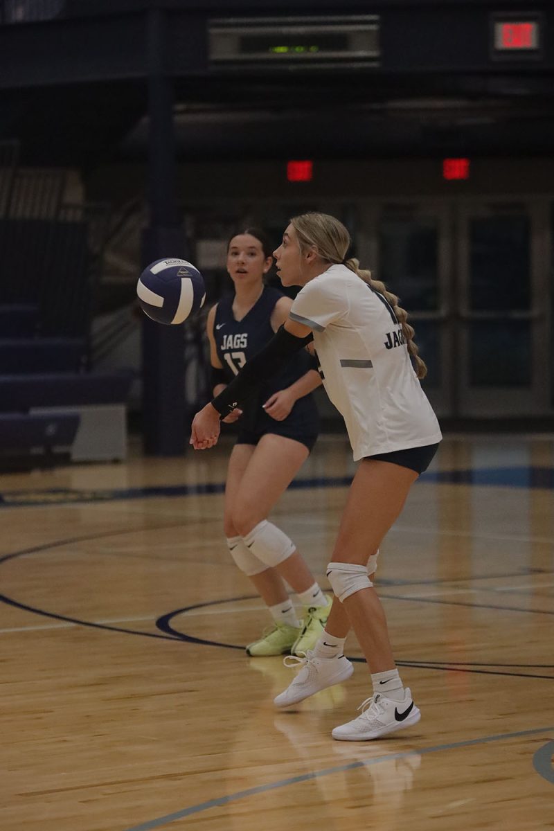 Extending her arms out, junior Corinne Schwindt passes the ball to a teammate Wednesday, Oct. 2.

