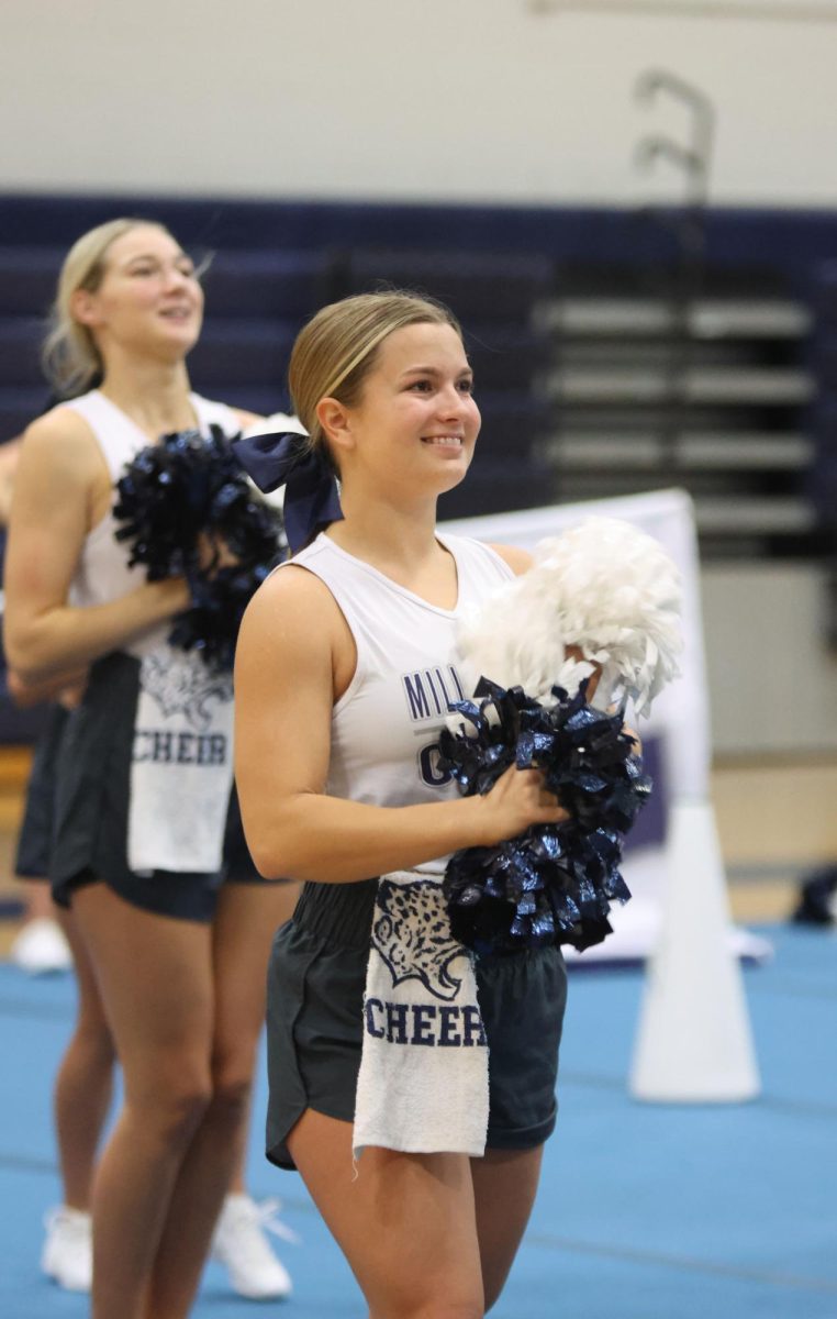 Smiling towards the stands, senior Joey Nightingale gets ready to perform her routine. 