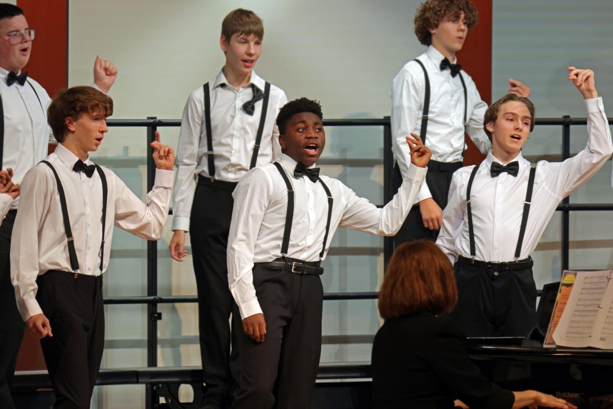 Snapping his fingers, freshman MJ Barton dances with the rest of the Tenor and Bass Choir.