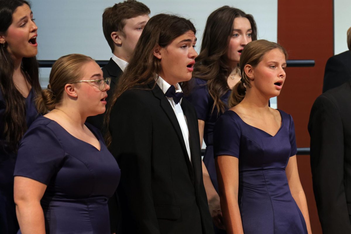 Senior Lilian Schleicher and juniors Keegan Wootton and Sienna Suderman sing with Jag Singers. 