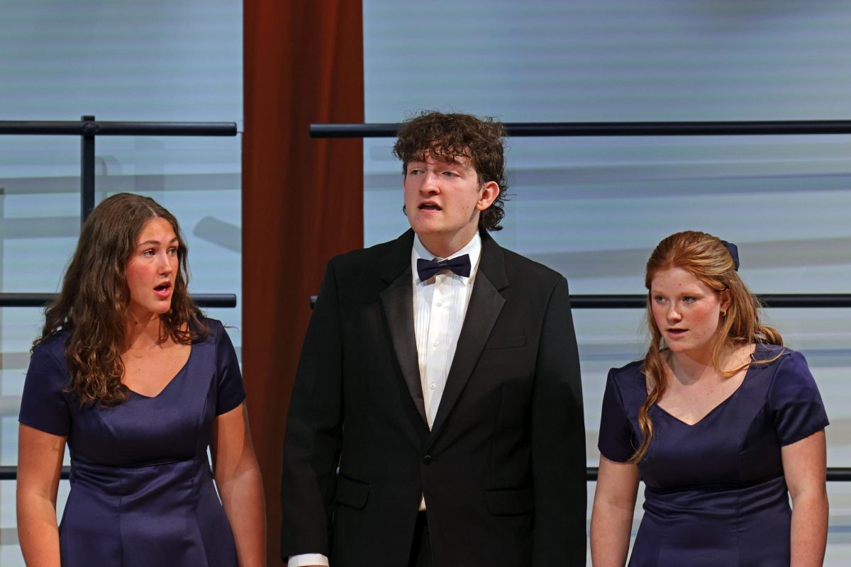 Performing with Jag Singers, seniors Lily Folendore and Blake Gray and sophomore Charlie Barrett sing “Flower of Beauty”.