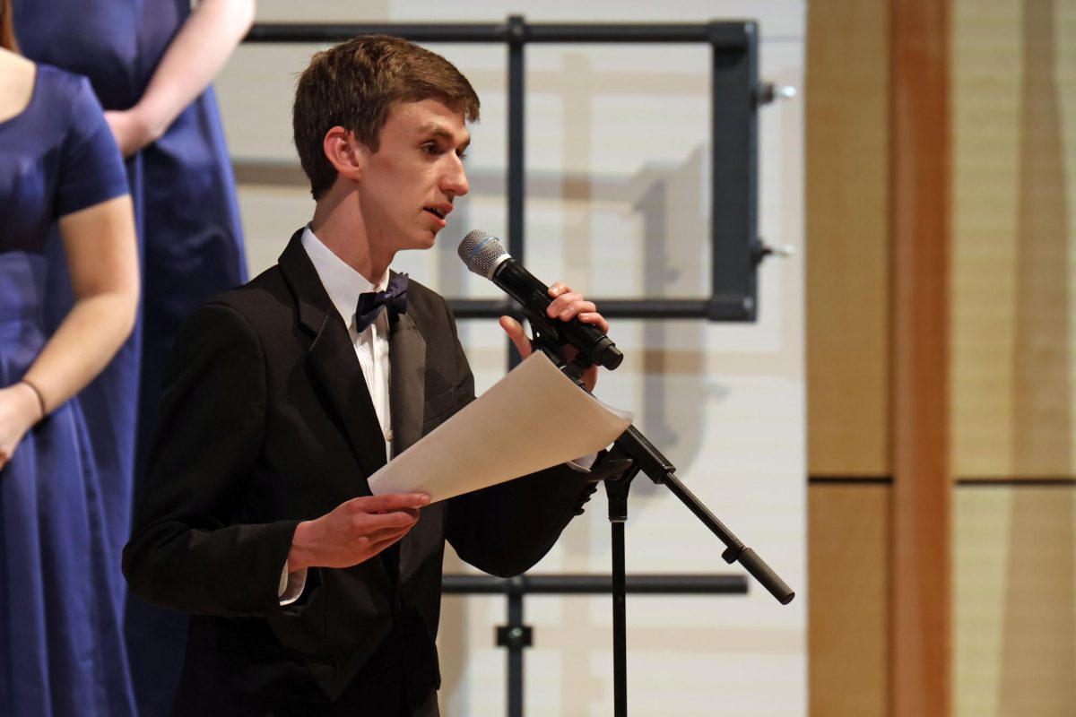 Senior Gabe Coleman speaks to the audience while introducing Chorale’s next song.