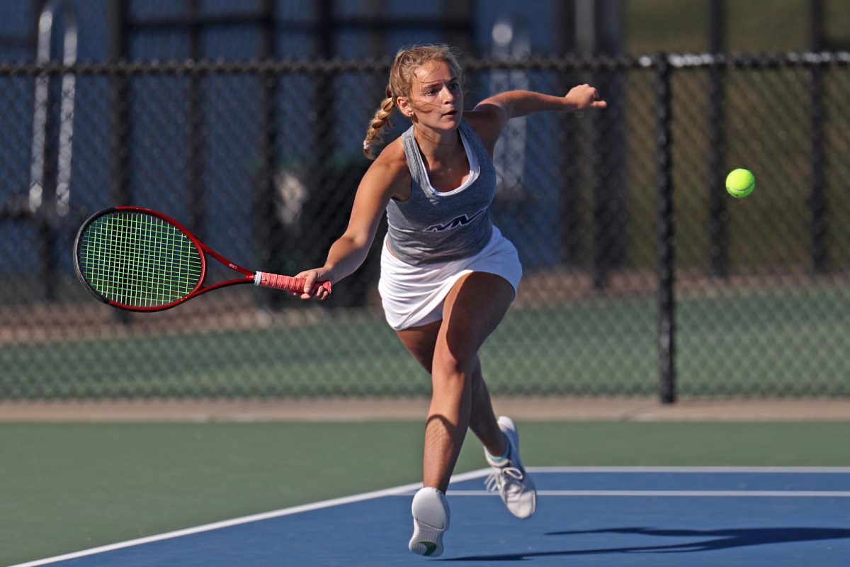 During her doubles match with partner junior Bryn Foltz, senior Marissa Hoelting runs to hit the ball.