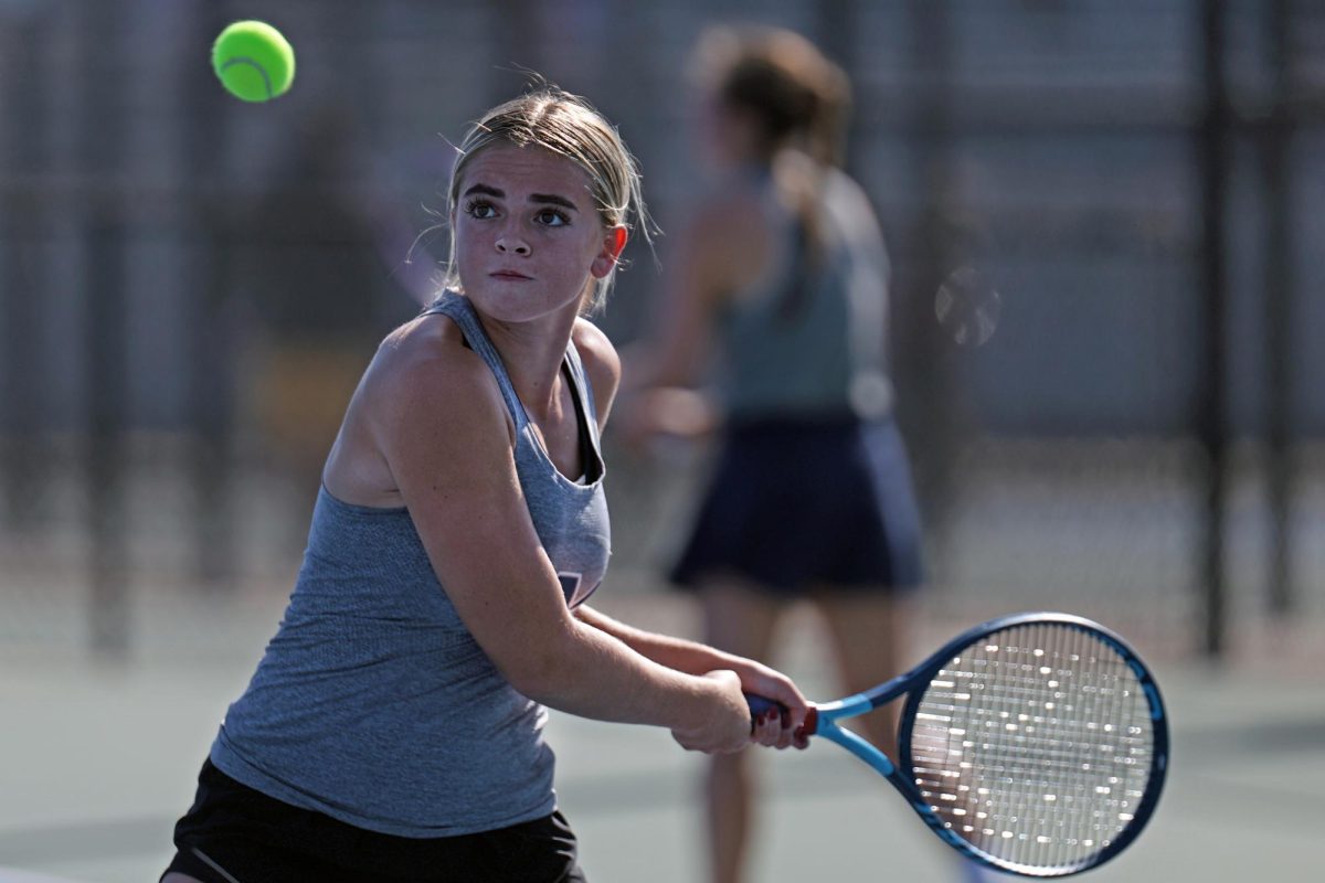 Eyes on the ball, senior Logan Miller pulls her arm back to swing. 