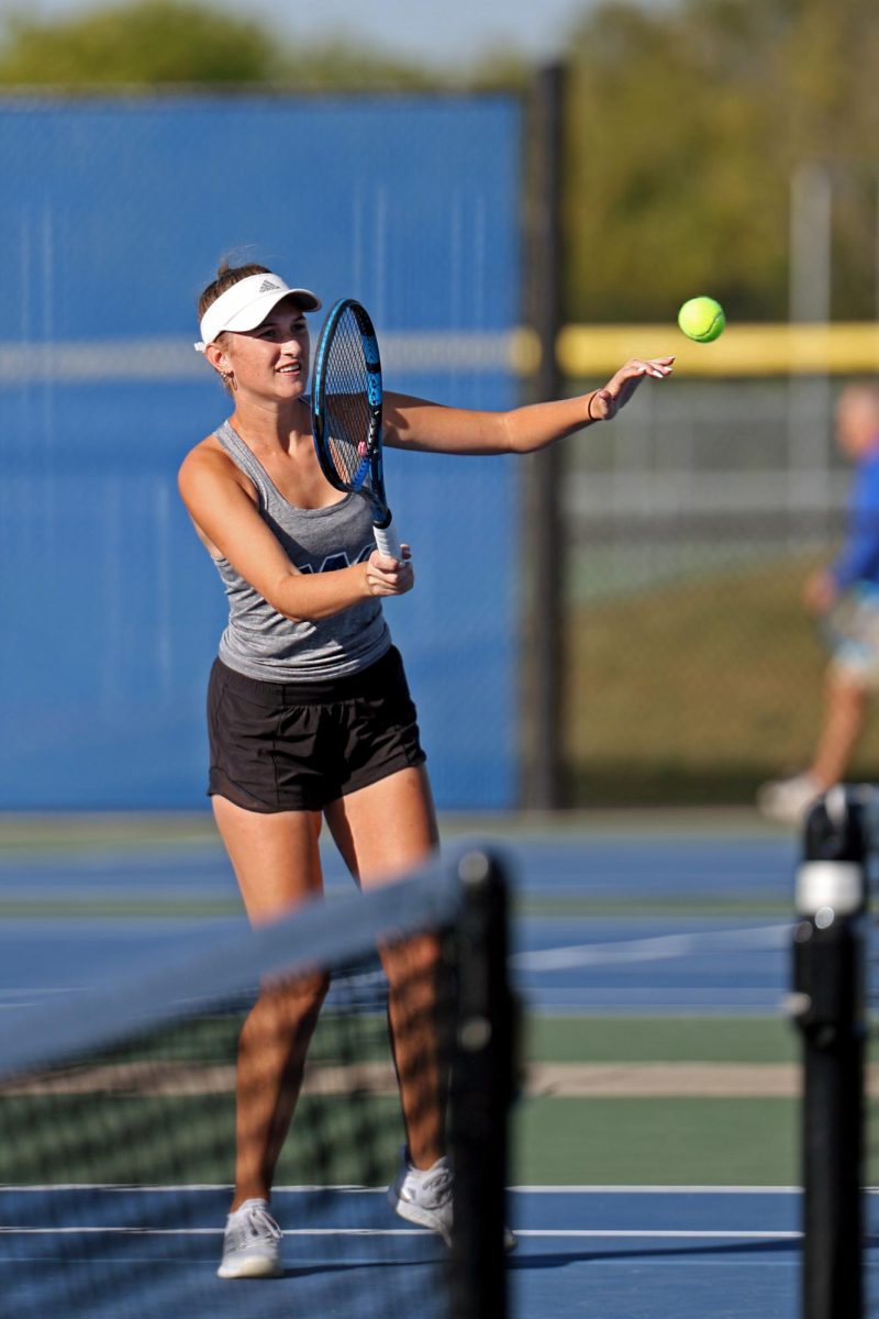 Senior Stella Platt returns the ball to her opponent.