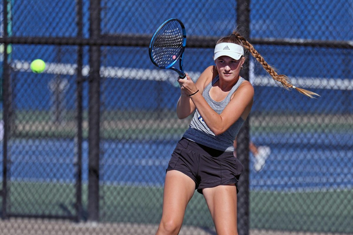 Senior Stella Platt returns the ball in a singles match.