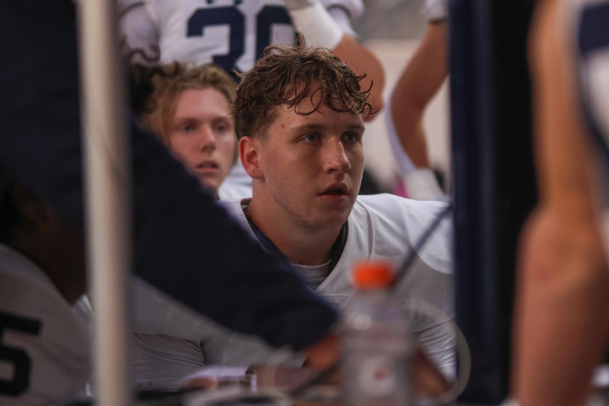 Senior Garrett Clark watches defensive film after coming off the field.