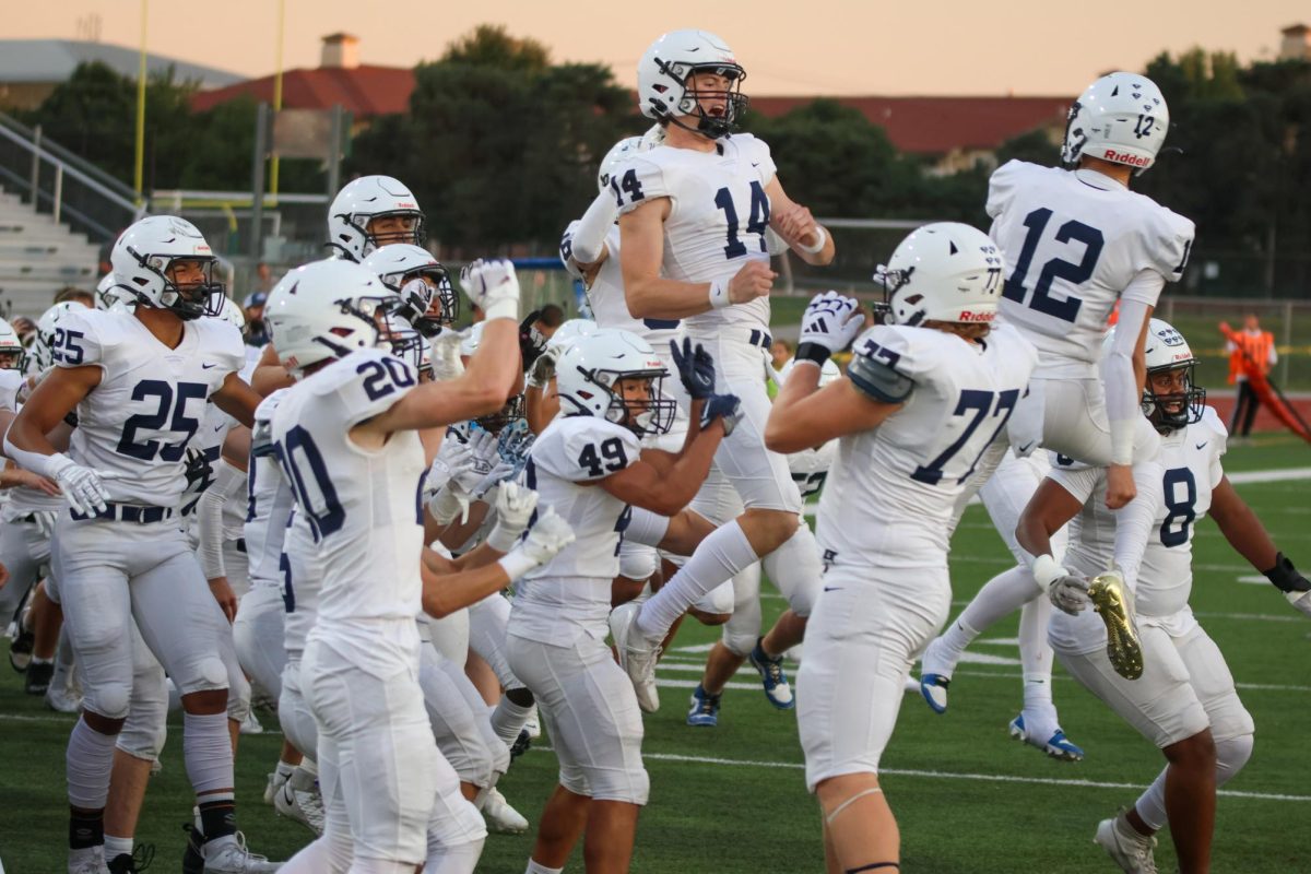 Junior Blake Jay and Senior Connor Bohon fly through the air together after the coin toss.