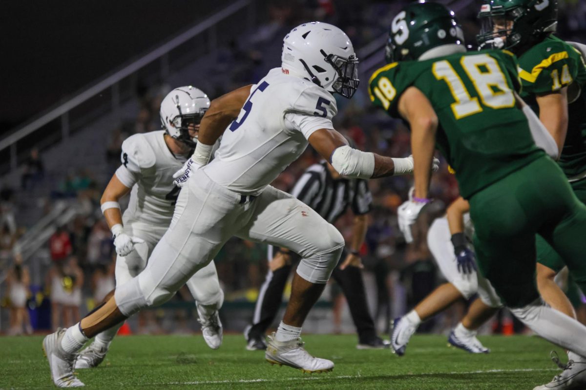 Senior Jayden Woods rushes towards the quarterback hoping for a tackle.