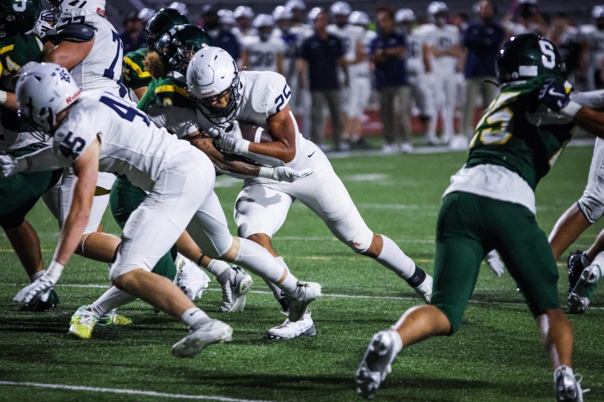 Junior Reggie Reece forces his way into the endzone for his third touchdown of the night.