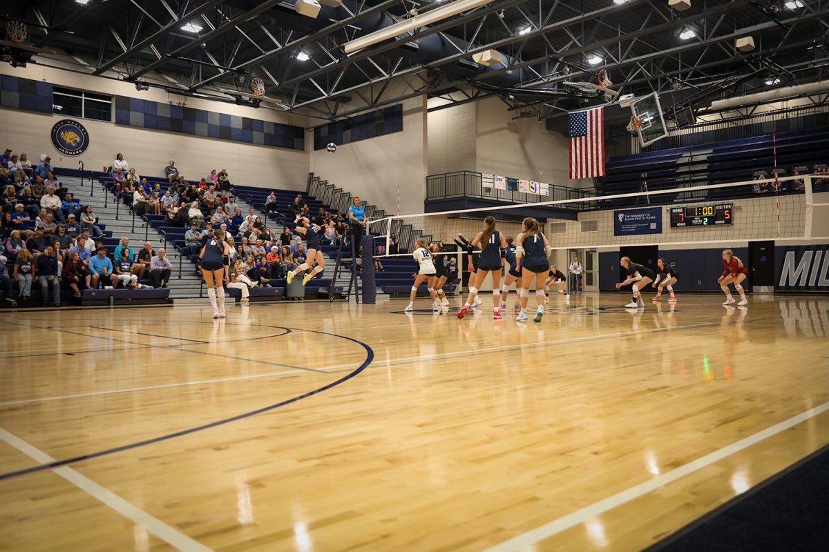 Freshman Sophia Sturdy leaps into action while everyone else watches