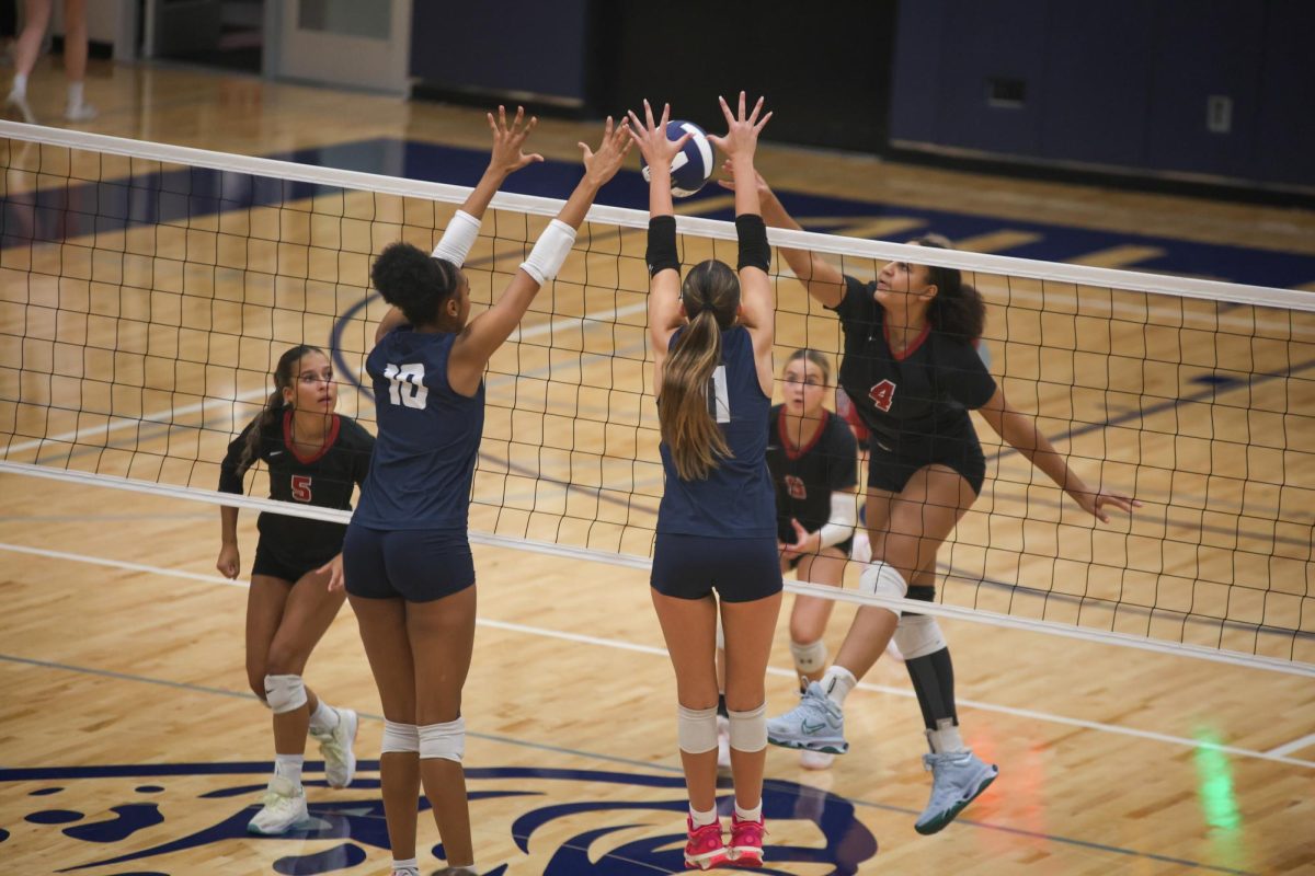 Juniors Leilah Perry and Ella Florez work together to get a block on an attempted spike. 