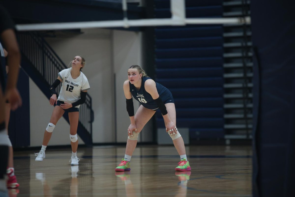 Sophomore Riley Riggs watches junior Corinne Schwindt's serve soar to the opposition's side. 