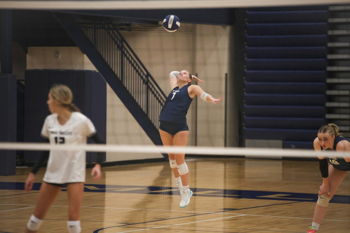 Senior Brynn McGillicuddy reaches back for a jump serve. 