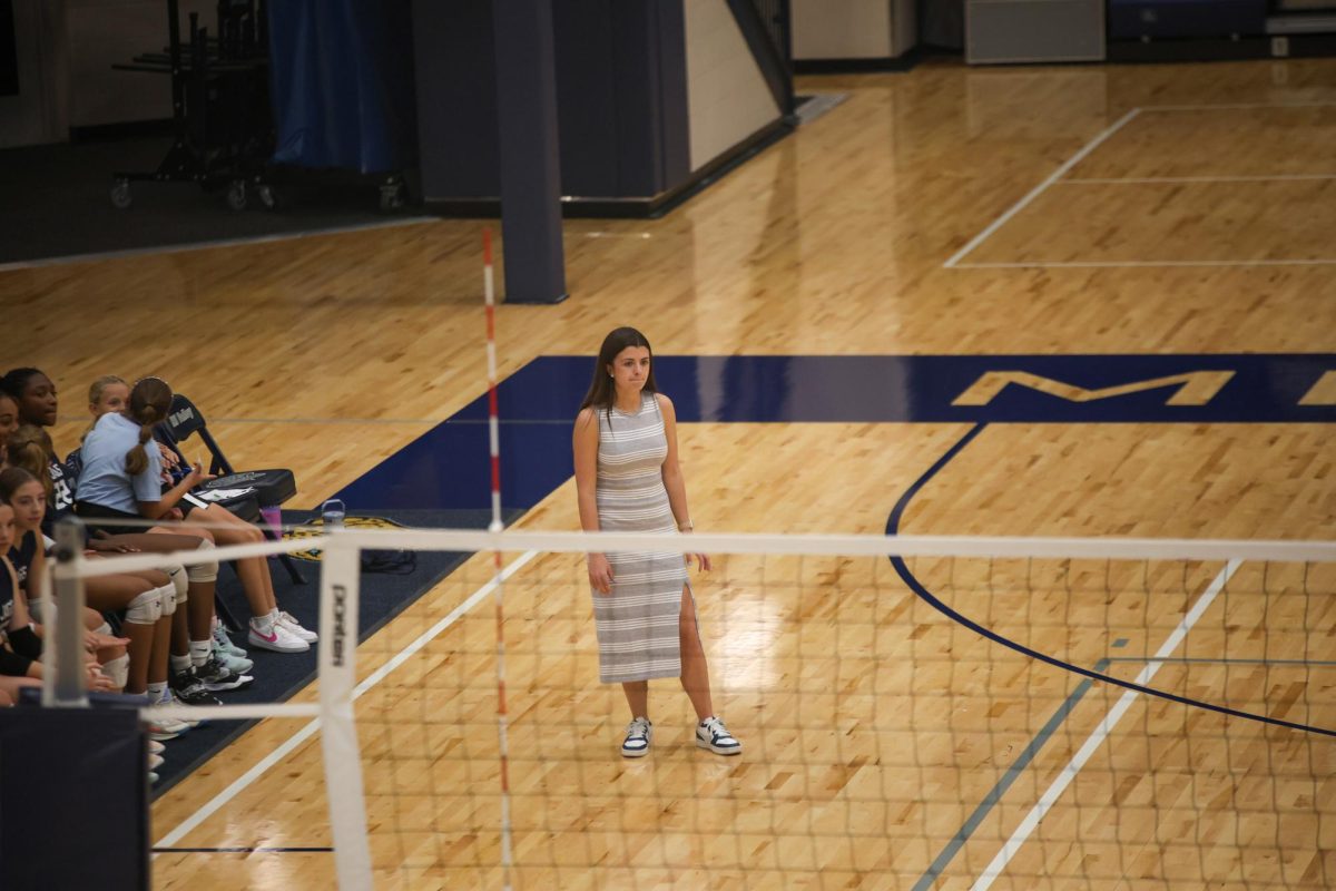 Head coach Kylie Corneliusen watches on as her team dominates Lawrence High School. 