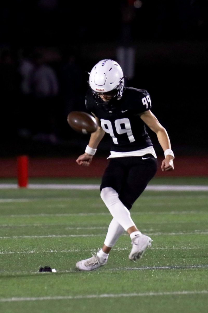 Senior Aiden Standley kicks-off after the team scored a touchdown.