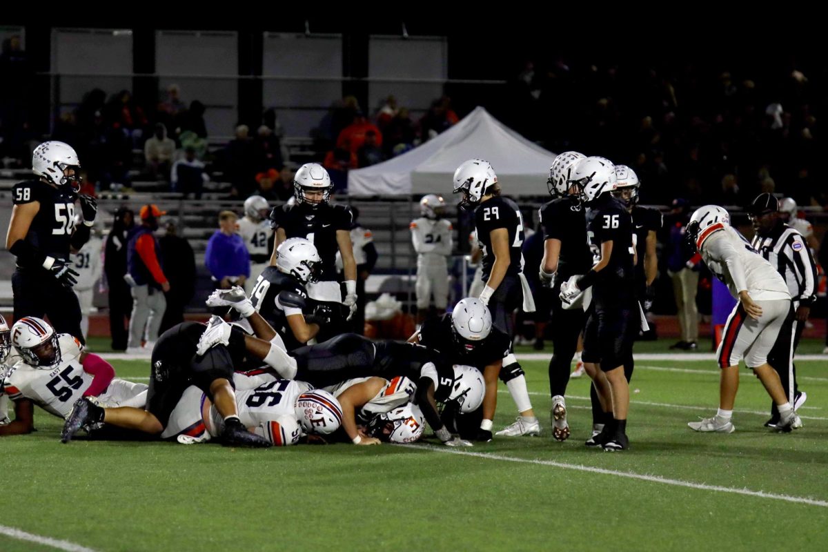 DogPile, senior Jayden Woods helps tackle an opposing player.