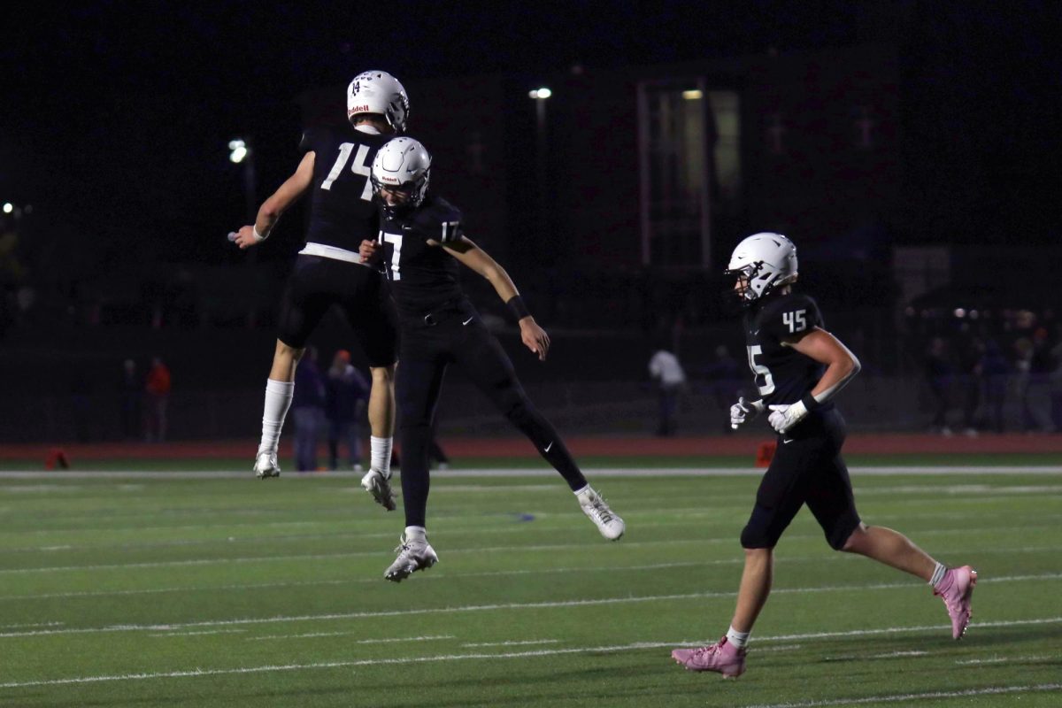 Excitement is in the Air , senior Connor Bohon, sophomore Holden Applebee, and junior Elliot Fischer celebrate after a successful play.