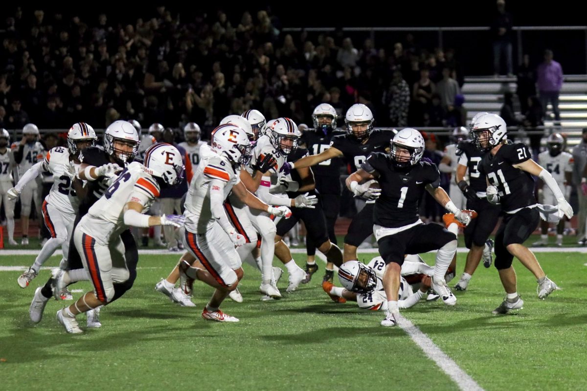 Ball in hand, senior Kye Jegen faces the defensive line.