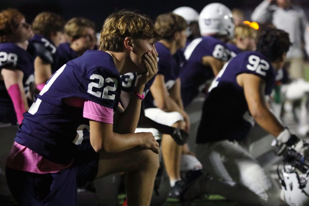 Junior Gavin Hurt takes a knee for his injured teammate.