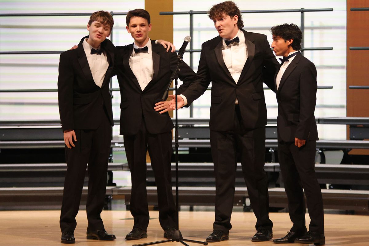 Singing together, junior Harrison Guest, seniors Zane Lauer, Blake Gray and Yazid Vazquez perform as a quartet.