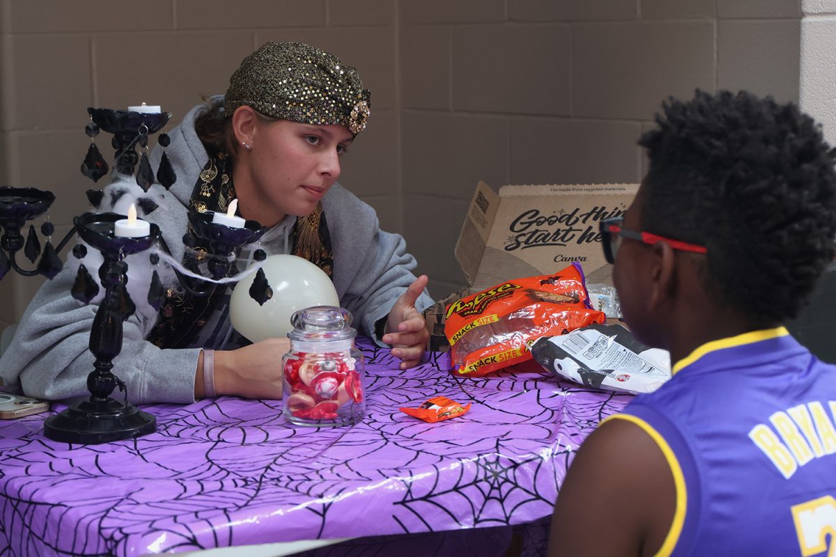 Telling fortunes, junior Sienna Suderman tells the Haunted Halls Participants their future predictions. 